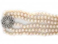 Cultured Pearl Three Strand Necklace with Large Diamond Set Flower Clasp
