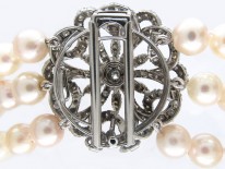 Cultured Pearl Three Strand Necklace with Large Diamond Set Flower Clasp