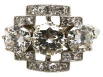 Art Deco Platinum & Three Stone Diamond Ring Within a Geometric Setting