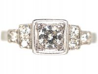 Art Deco Platinum, Diamond Solitaire Ring with Step Cut Shoulders set with Diamonds