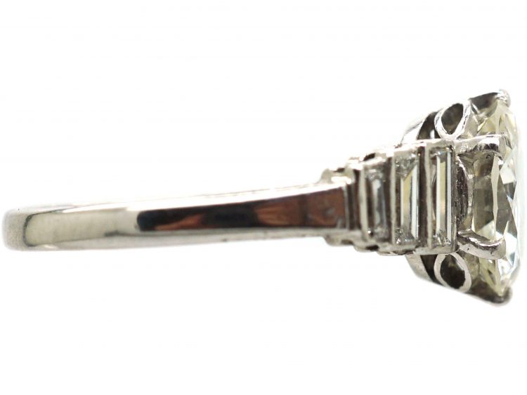 Art Deco Platinum, Transitional Cut Diamond Solitaire Ring with Step Cut Shoulders set with Baguette Diamonds