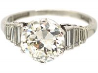 Art Deco Platinum, Transitional Cut Diamond Solitaire Ring with Step Cut Shoulders set with Baguette Diamonds
