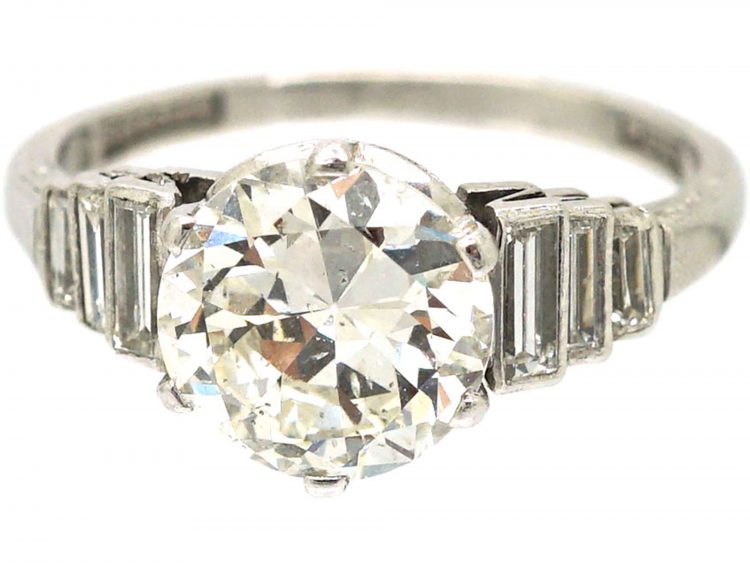Art Deco Platinum, Transitional Cut Diamond Solitaire Ring with Step Cut Shoulders set with Baguette Diamonds