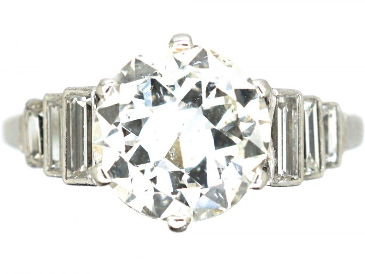 Art Deco Platinum, Transitional Cut Diamond Solitaire Ring with Step Cut Shoulders set with Baguette Diamonds