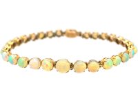 Retro 9ct Gold Bracelet set with a Line of Graduated Opals
