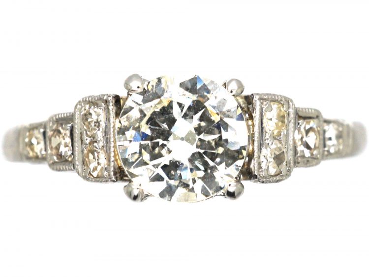Art Deco Platinum Solitaire Diamond Ring with Step Cut Shoulders set with Diamonds