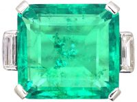 Art Deco Platinum Ring set with a Large Colombian Emerald with Diamond Baguette Shoulders