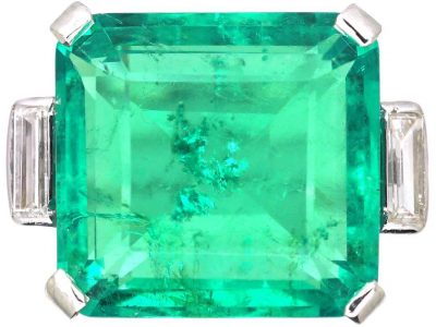 Art Deco Platinum Ring set with a Large Colombian Emerald with Diamond Baguette Shoulders