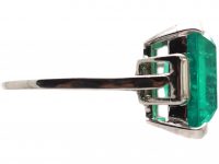 Art Deco Platinum Ring set with a Large Colombian Emerald with Diamond Baguette Shoulders