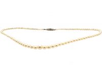 Early 20th Century Graduated Cultured Pearl Necklace with an 18ct White Gold, Emerald & Diamond Clasp