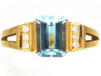 18ct Gold Ring set with a Rectangular Cut Aquamarine with Diamonds on Either Side