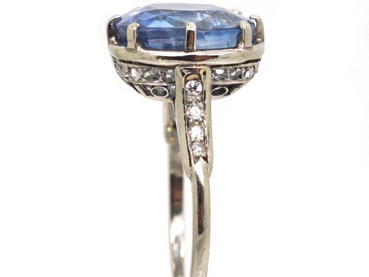 Early 20th Century Platinum Ring set with a Large Sapphire with Diamond Detail