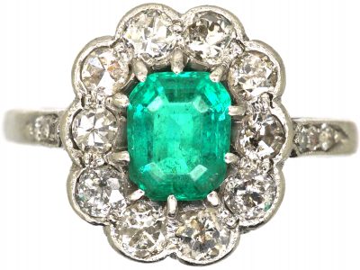 Edwardian Platinum Cluster Ring set with an Emerald & Diamonds