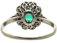 Edwardian Platinum Cluster Ring set with an Emerald & Diamonds