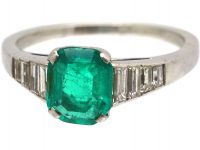 Art Deco 18ct White Gold Ring set with an Emerald with Step Cut Diamond Shoulders