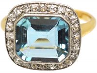 Edwardian 18ct Gold & Platinum Ring set with an Aquamarine with a Diamond Border