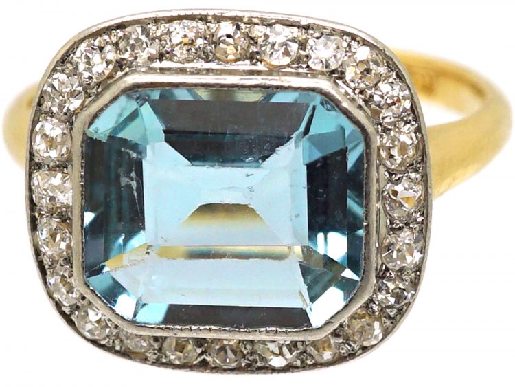 Edwardian 18ct Gold & Platinum Ring set with an Aquamarine with a Diamond Border