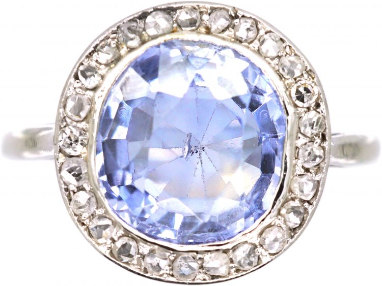 Early 20th Century Platinum Ring set with a Ceylon Sapphire Surrounded by Rose Diamonds