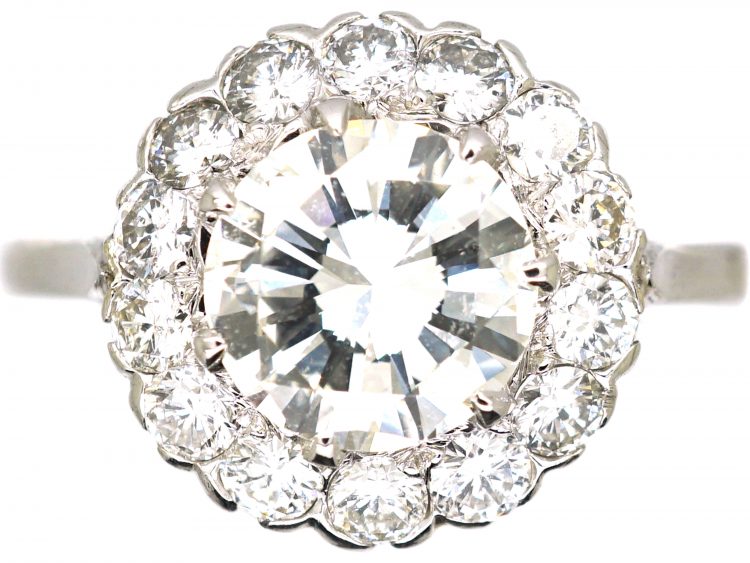 Mid 20th Century Platinum Diamond Cluster Ring set with 1.50 Carat Centre Diamond