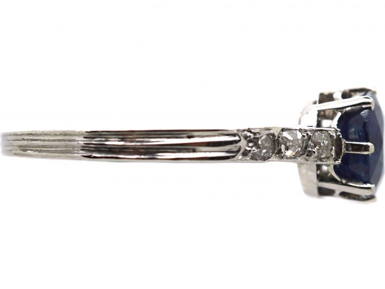 Early 20th Century Platinum Ring set with a Sapphire with Diamond set Shoulders