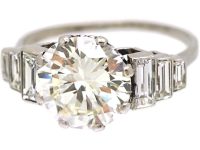 Art Deco Platinum, Diamond Solitaire Ring with Step Cut Shoulders set with Baguette Diamonds