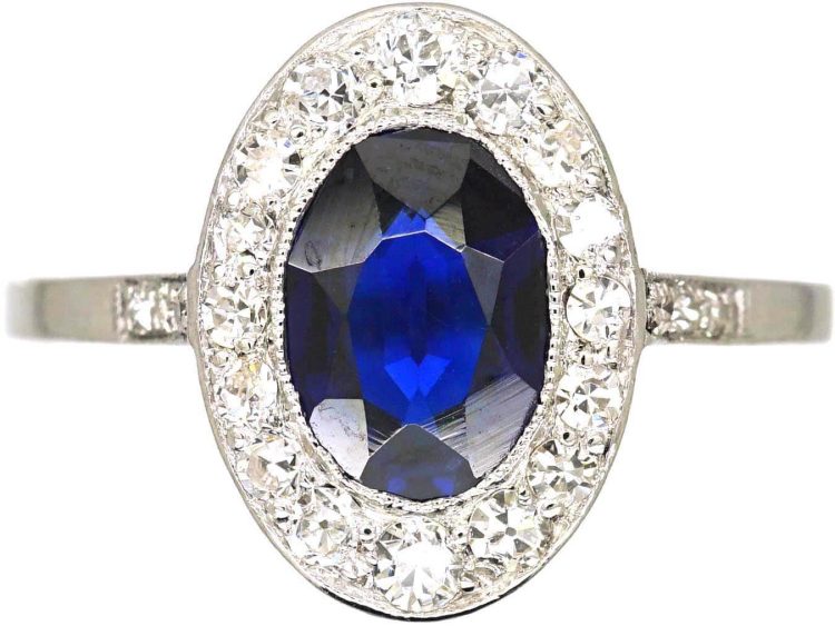 Early 20th Century Platinum Ring set with an Oval Cut Sapphire & Diamonds