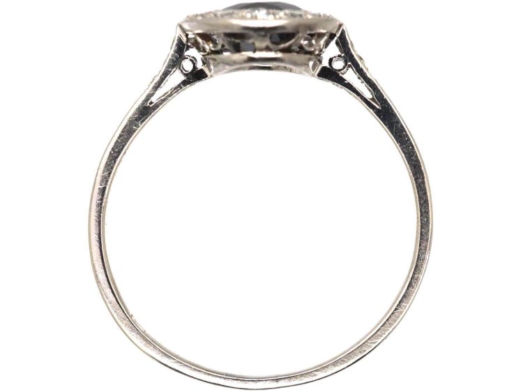 Early 20th Century Platinum Ring set with an Oval Cut Sapphire & Diamonds