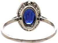 Early 20th Century Platinum Ring set with an Oval Cut Sapphire & Diamonds