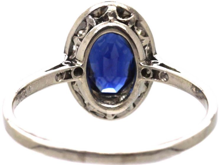 Early 20th Century Platinum Ring set with an Oval Cut Sapphire & Diamonds