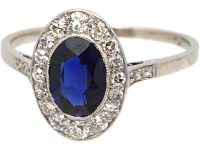 Early 20th Century Platinum Ring set with an Oval Cut Sapphire & Diamonds
