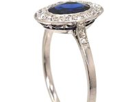 Early 20th Century Platinum Ring set with an Oval Cut Sapphire & Diamonds