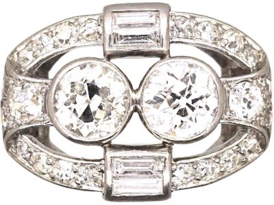 Art Deco Platinum Two Stone Diamond Ring with an Oval Surround of Baguette & Round Diamonds
