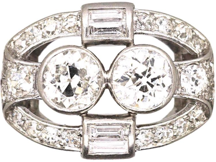 Art Deco Platinum Two Stone Diamond Ring with an Oval Surround of Baguette & Round Diamonds
