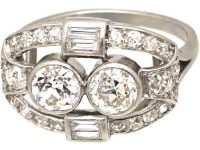 Art Deco Platinum Two Stone Diamond Ring with an Oval Surround of Baguette & Round Diamonds