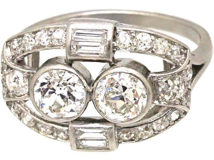 Art Deco Platinum Two Stone Diamond Ring with an Oval Surround of Baguette & Round Diamonds