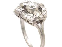 Art Deco Platinum Two Stone Diamond Ring with an Oval Surround of Baguette & Round Diamonds
