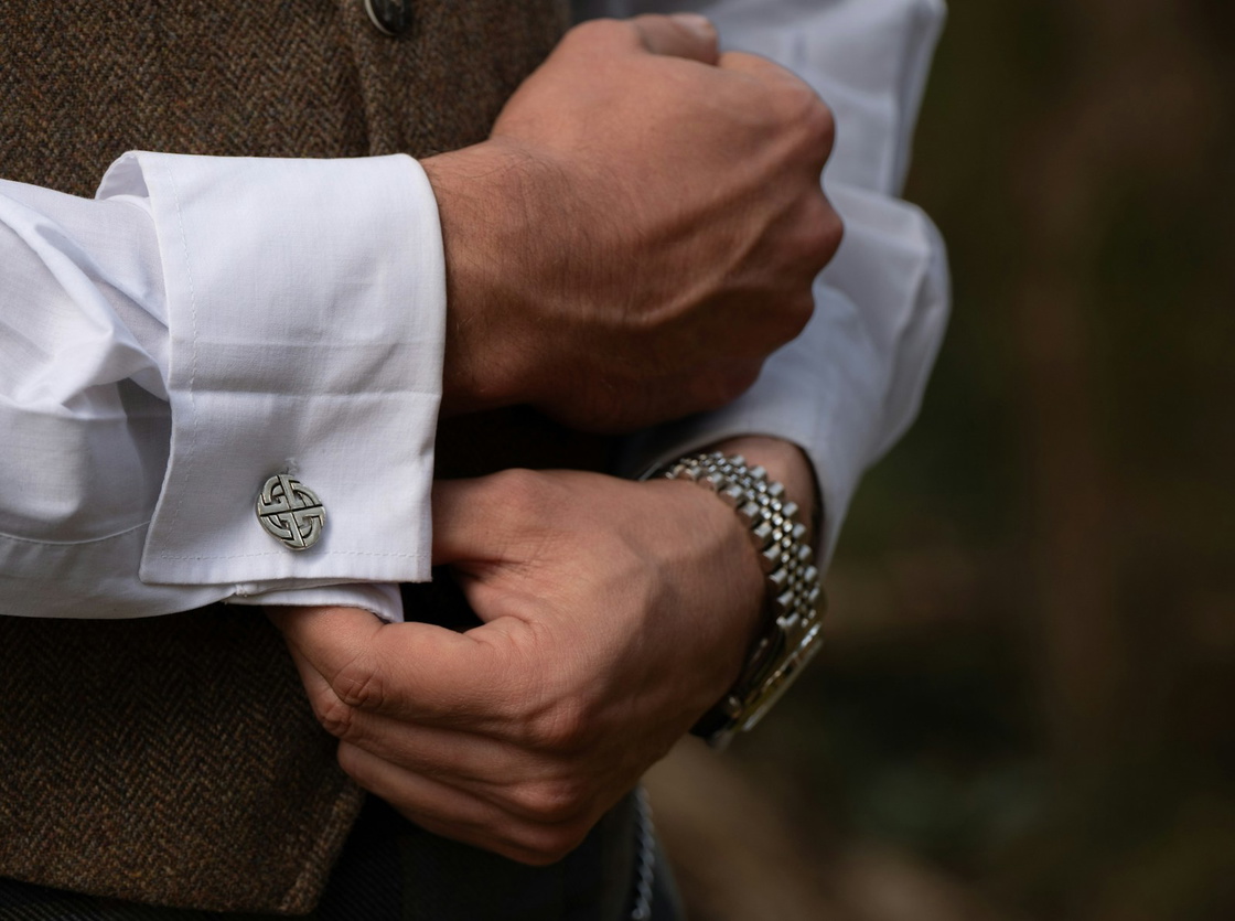 A man adjusting his cufflinks