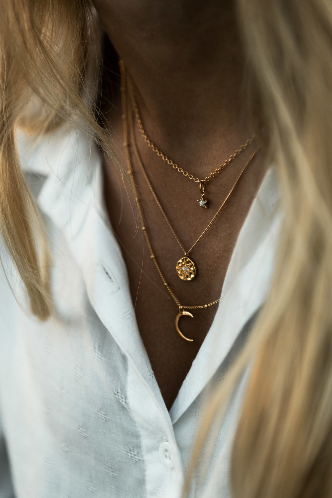 Layered gold necklaces of different lengths