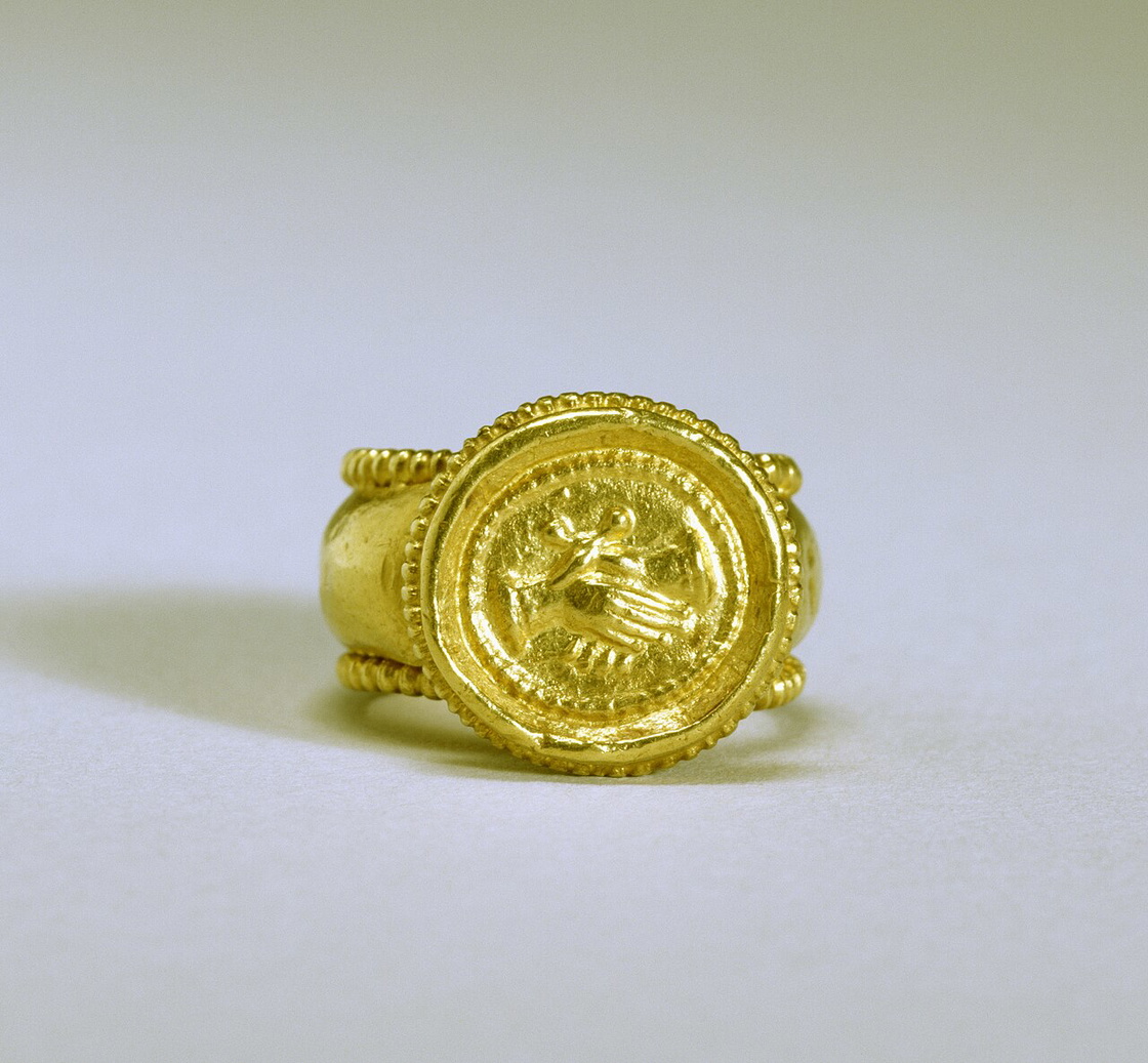 Gold Byzantine marriage ring with clasped hands